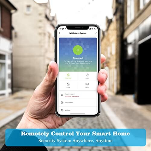 Person holding smartphone displaying smart home control app on a blurred street background.