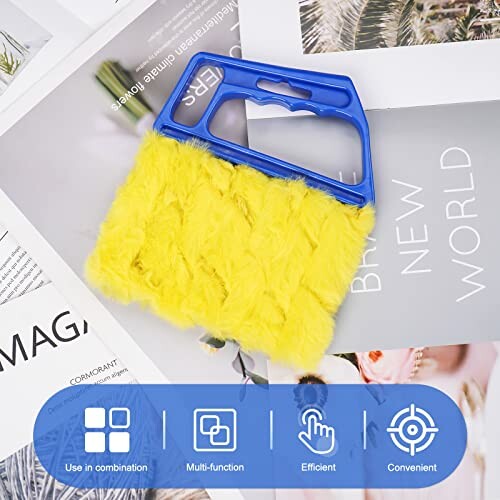 Yellow cleaning brush with blue handle on magazines